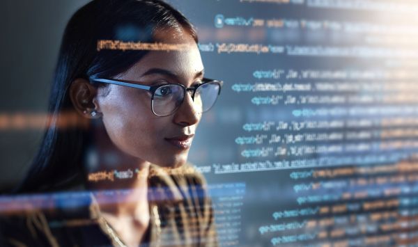 Woman with glasses looking through code