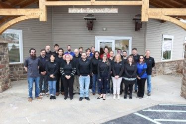 The Intrada Team, standing together in front of Intrada