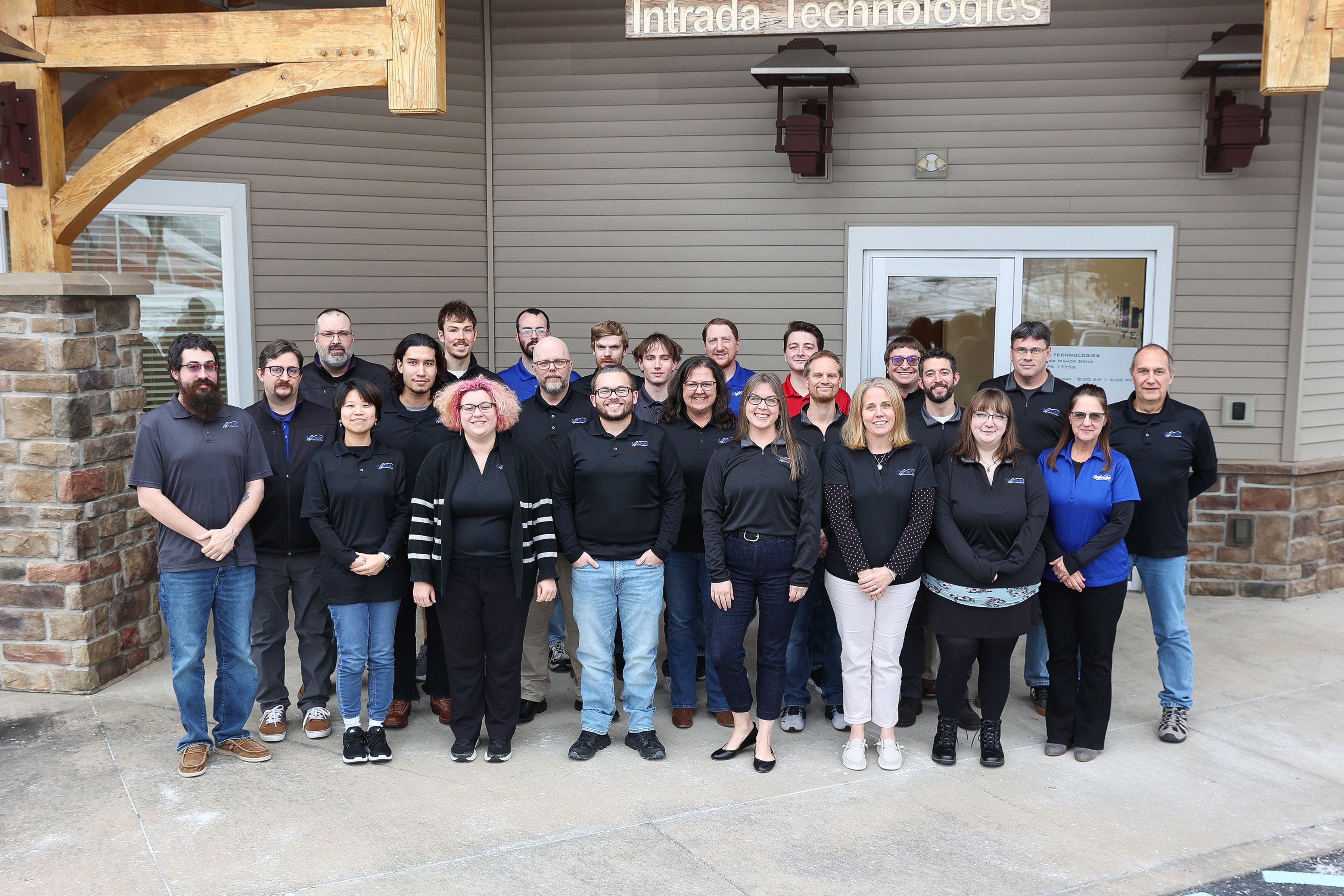 Intrada team standing together in front of Intrada