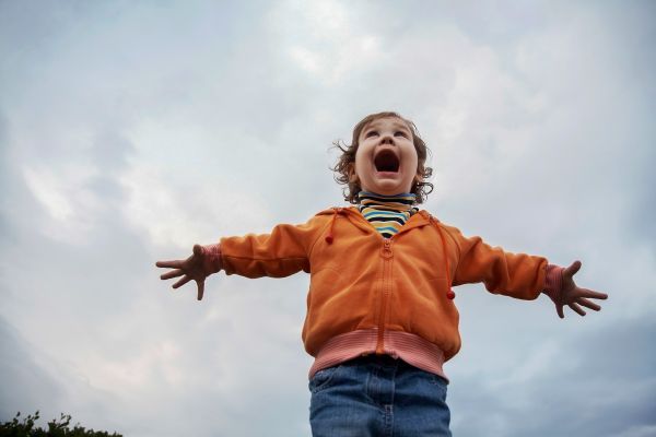 Child enjoying the cloudy outdoors